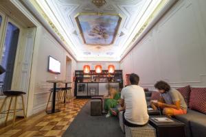 a group of people sitting in a living room at Toc Hostel Madrid in Madrid