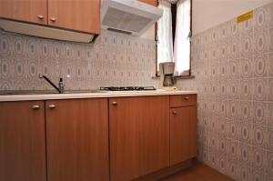 a kitchen with a sink and a counter top at Villaggio Giove in Lignano Sabbiadoro