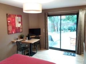 a room with a desk with a computer and a window at Le Clos des Barelles in Six-Fours-les-Plages