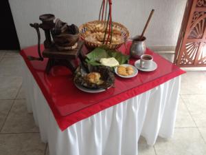 a table with a plate of food on top of it at Hotel Casa Pablo in Neiva