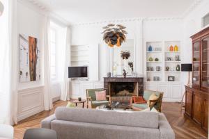 a living room with a couch and a fireplace at Intendance beautiful apartment in Bordeaux