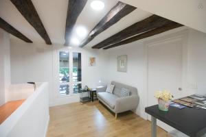 a living room with a couch and a table at LUXURY IN OLD TOWN NEAR BEACH by www,SanSebastianApartments,es in Donostia-San Sebastián