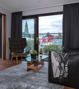 a living room with a view of a city at ION City Hotel, Reykjavik, a Member of Design Hotels in Reykjavík