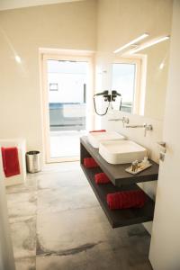 a bathroom with a sink and a large mirror at Haus Christine in Zell am See