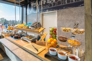 a buffet line with food on a table at ibis budget Geneve Palexpo Aeroport in Geneva