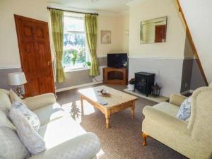 a living room with two couches and a coffee table at Fell Cottage in Keighley