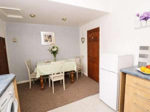 a kitchen with a table and a kitchen with a dining room at Fell Cottage in Keighley +11 photos