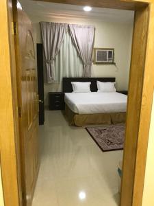 מיטה או מיטות בחדר ב-رفيف الشمال - الحائط Rafeef Al Shamal