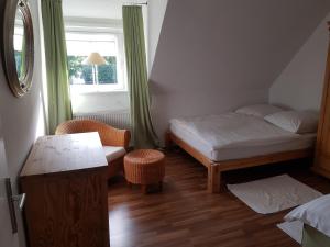 a small bedroom with a bed and a window at Apartment am Park in Lehrte