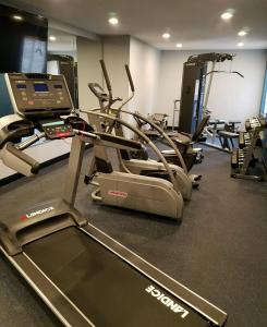 a gym with treadmills and elliptical machines at Best Western On The Avenue in Buffalo