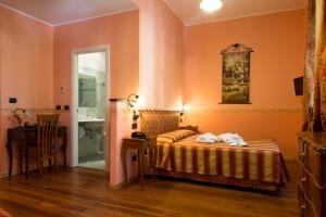 Postel nebo postele na pokoji v ubytování Hotel Belle Epoque