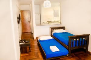 2 camas en una habitación pequeña con espejo en Apartamento Obispo Trejo III by Lofty en Córdoba