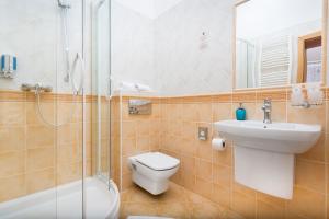 a bathroom with a toilet and a sink and a shower at Penzión Hradbová Residence & Spa in Košice