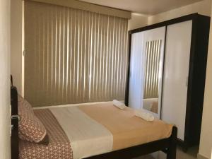 Ένα ή περισσότερα κρεβάτια σε δωμάτιο στο Férias na praia de Ponta Verde