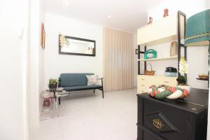 a living room with a black cabinet and a chair at Alojamento das Fontes in Alenquer