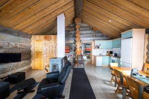 a living room with a couch and a tv in a house at Osman Kelohovi in Utsjoki +33 photos