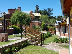 a wooden fence in front of a house at Complejo Don Osvaldo in Sierra de la Ventana