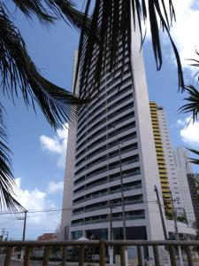 a tall building with a palm tree in front of it at Dunna Barcane in Natal