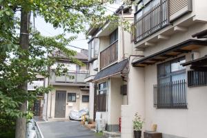 a row of apartment buildings with balconies at Aoi-Riverside Old Townhouse in Kyoto