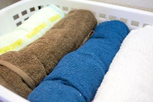 a white basket filled with towels and a blue sock at Aoi-Riverside Old Townhouse in Kyoto +53 photos