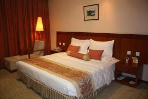 a bedroom with a large bed in a hotel room at Super House International in Beijing