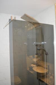 a glass shower with a toilet and a sink at Recoleta Deluxe Studio in Buenos Aires +32 photos