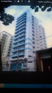 a view of a tall white building at Apart Quartier Latin in Vitória