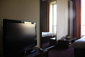 a living room with a large flat screen tv in a hotel room at Apart Rooms Marszalkowska by WarsawResidence Group in Warsaw