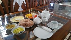 a glass table with a breakfast of eggs and food at Brave resort Mirissa in Mirissa
