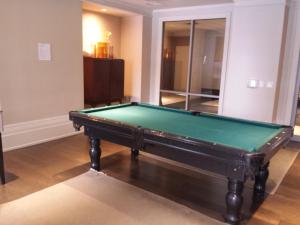 a pool table sitting in a living room with at BEST LOCATION/SPECTACULAR VIEW 2 BEDROOMS FURNISHED CONDO S/L RENT in Mississauga