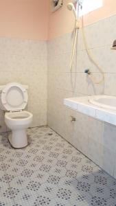 a bathroom with a toilet and a sink at Montra Guesthouse in Ranong +7 photos