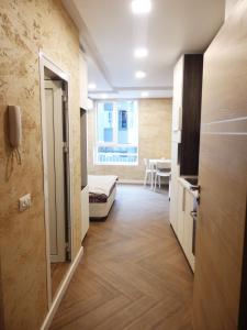 a room with a hallway with a bed and a table at Luxury apartment in Sofia
