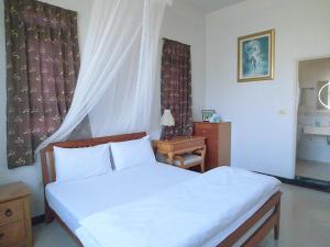 Llit o llits en una habitació de Flower Memory Homestay
