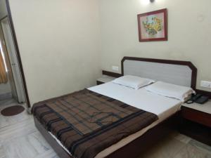 a bedroom with a large bed with at Modern Hotel in Bangalore