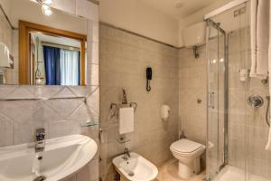 a bathroom with a sink and a toilet and a shower at Hotel Franklin Feel The Sound in Rome