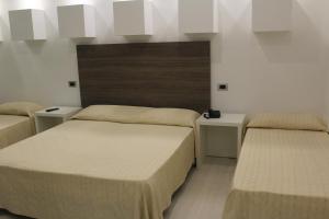 A bed or beds in a room at Hotel Miramare