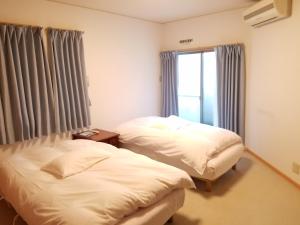 Postel nebo postele na pokoji v ubytování Villa M Guesthouse