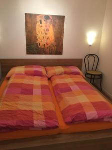 a bedroom with a bed with a colorful blanket at Haus Melodie in Wiler