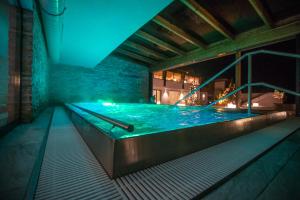 a large swimming pool in a building at night at Hotel NockResort in Bad Kleinkirchheim