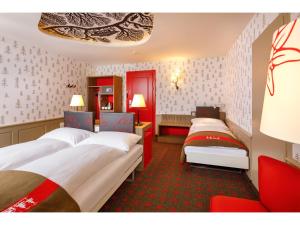 a hotel room with two beds and a desk at Swiss Night by Fassbind in Zürich