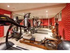 a gym with several treadmills and machines in it at Swiss Night by Fassbind in Zurich