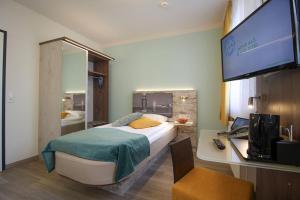 מיטה או מיטות בחדר ב-City Hotel