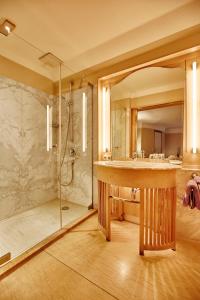 a bathroom with a large sink and a shower at Hotel Gutsgasthof Stangl in Neufarn