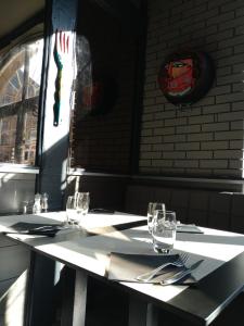 a table with glasses and utensils on top of it at Relais Lorraine Alsace Pere & Fils in Raon-lʼÉtape