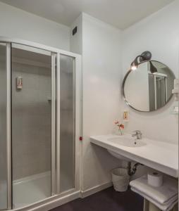 a bathroom with a shower and a sink and a mirror at Hotel Gattopardo in Dossobuono