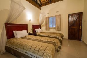 Säng eller sängar i ett rum på Ravine Lodge