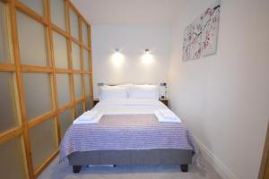a bedroom with a large bed in a room at 3A Soho Studios 3rd floor by Indigo Flats in London