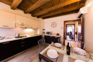 cocina con mesa, sillas y encimera en Arena Dreams Apartment, en Verona
