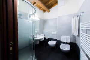 a bathroom with two toilets and a sink at Arena Dreams Apartment in Verona +35 photos