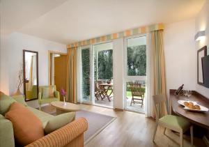 a living room with a couch and a table at Valamar Tamaris Resort in Poreč